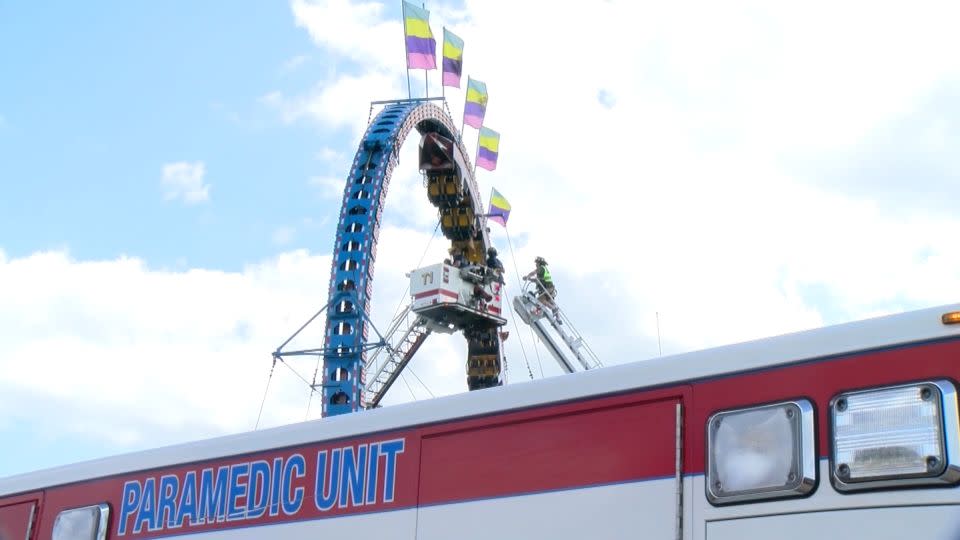 Emergency personnel work to remove people from a stuck roller coaster in Crandon, Wisconsin, on July 2. - WJFW