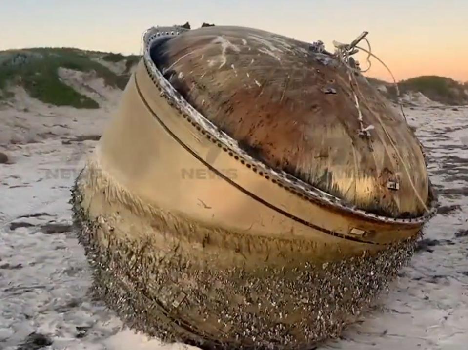 The mysterious giant cylinder washed up on an Australian beach (screengrab/7News)