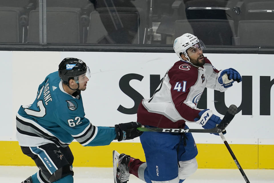 Colorado Avalanche center Pierre-Edouard Bellemare (41) looks toward the puck in front of San Jose Sharks right wing Kevin Labanc (62) during the first period of an NHL hockey game in San Jose, Calif., Monday, March 1, 2021. (AP Photo/Jeff Chiu)