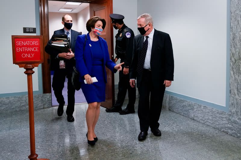 FILE PHOTO: Senators Klobuchar and Durbin depart the Senate Judiciary Committee hearing on Judge Barrett's nomination to serve on the U.S. Supreme Court in Washington