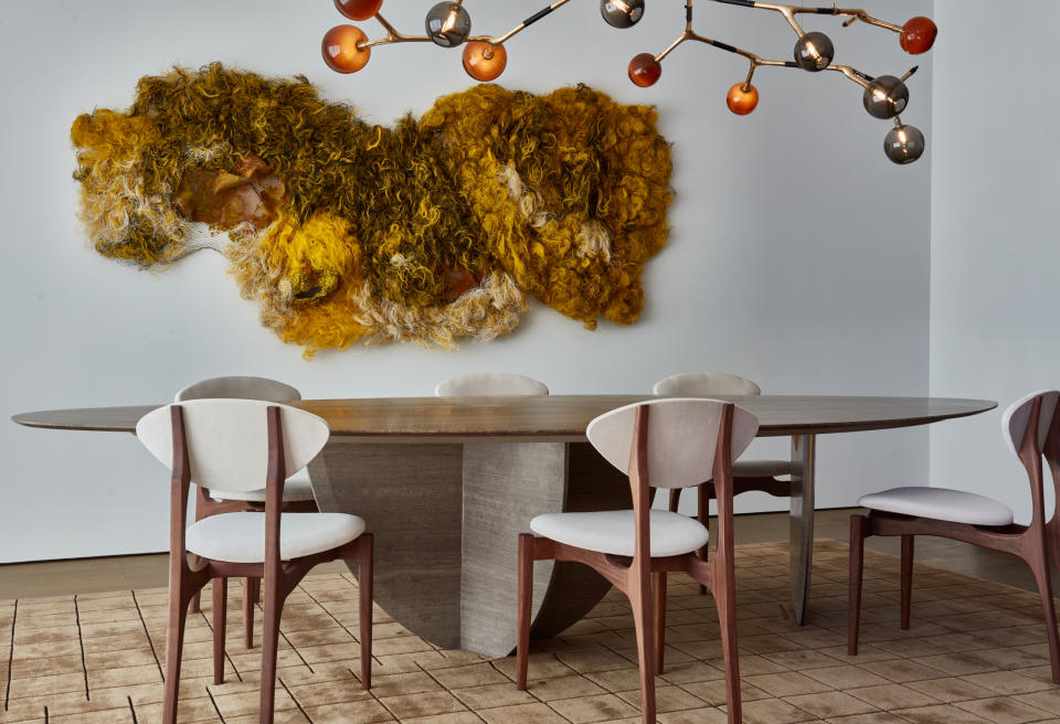 dining room with wood oval table and chairs in with wood frame and white seat, large light over table