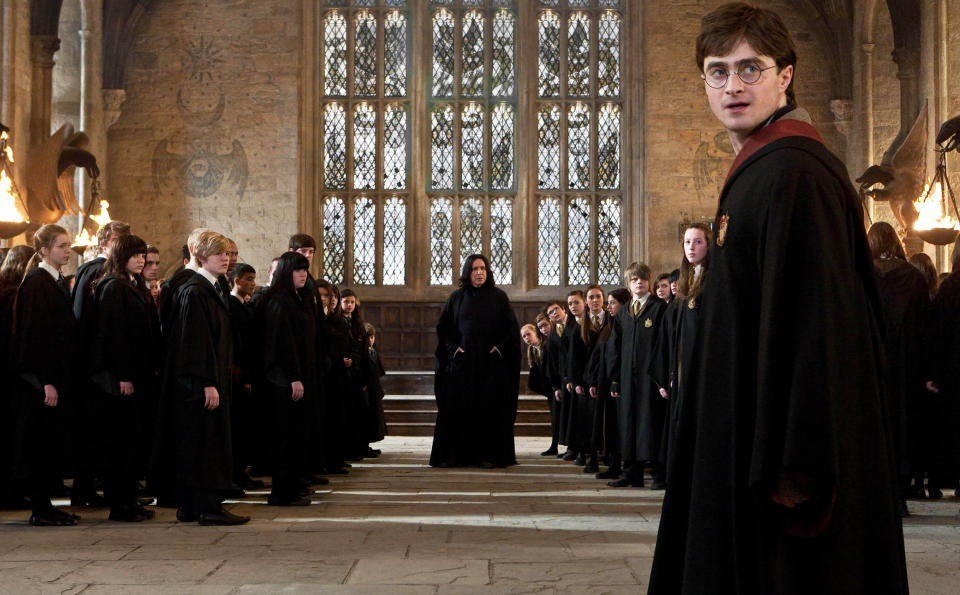 Alan Rickman (center) and Daniel Radcliffe (right, foreground) in “Harry Potter and The Deathly Hallows.