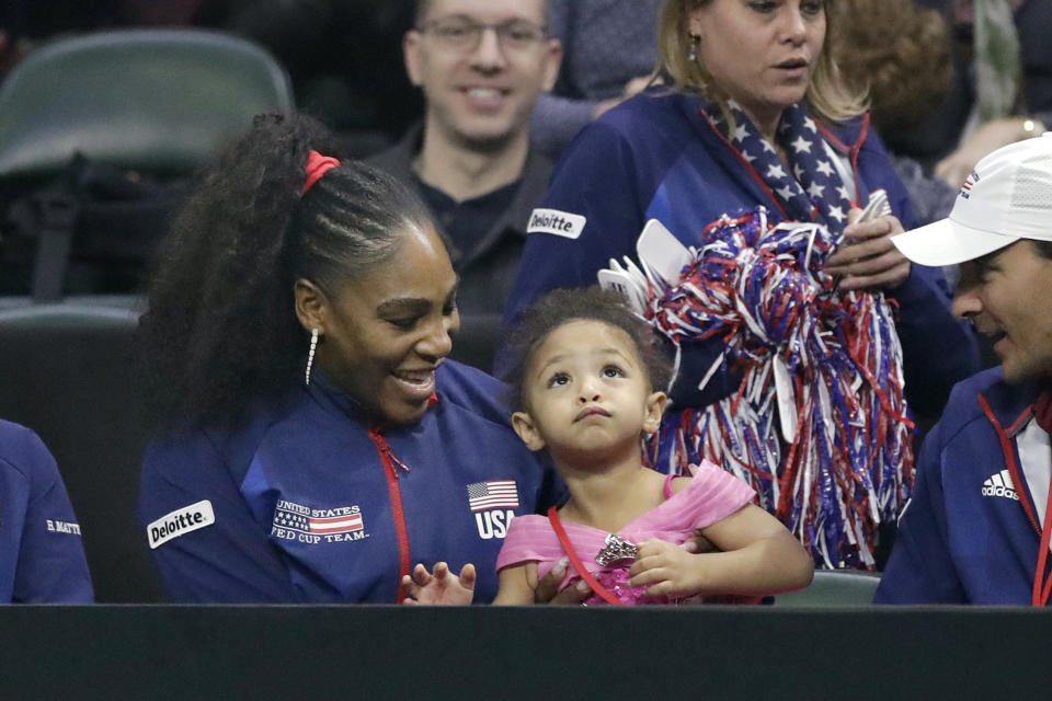 United States' Serena Williams sits with her daughter, Alexis Olympia Ohanian Jr., as they look on during a Fed Cup qualifying tennis match Saturday, Feb. 8, 2020, in Everett, Wash. (AP Photo/Elaine Thompson)