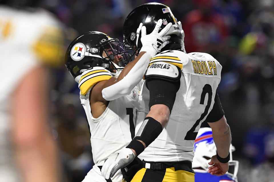 Pittsburgh Steelers wide receiver Calvin Austin III (19) celebrates with quarterback Mason Rudolph (2) after scoring a touchdown against the Buffalo Bills during the fourth quarter of an NFL wild-card playoff football game, Monday, Jan. 15, 2024, in Buffalo, N.Y. (AP Photo/Adrian Kraus)