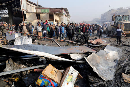 People gather at the site of a car bomb attack at a vegetable market in eastern Baghdad, Iraq, January 8, 2017. REUTERS/Wissm al-Okili