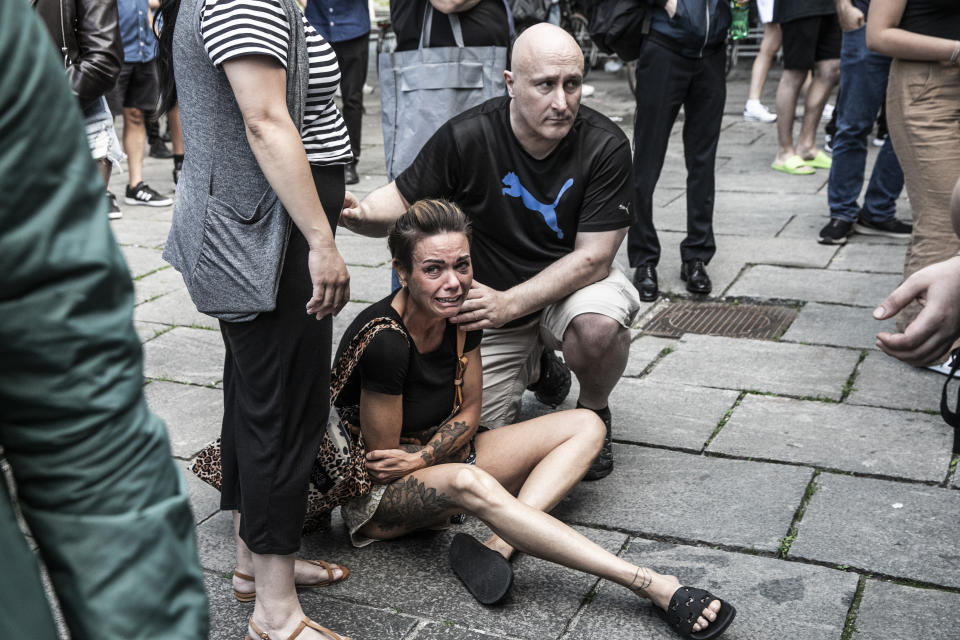 People help a woman in front of the Fields shopping center in Copenhagen, Denmark, Sunday, July 3, 2022. A gunman opened fire inside the busy shopping mall in the Danish capital Sunday, killing a few people and critically wounding a few others, police said. (Olafur Steinar Rye Gestsson/Ritzau Scanpix via AP)