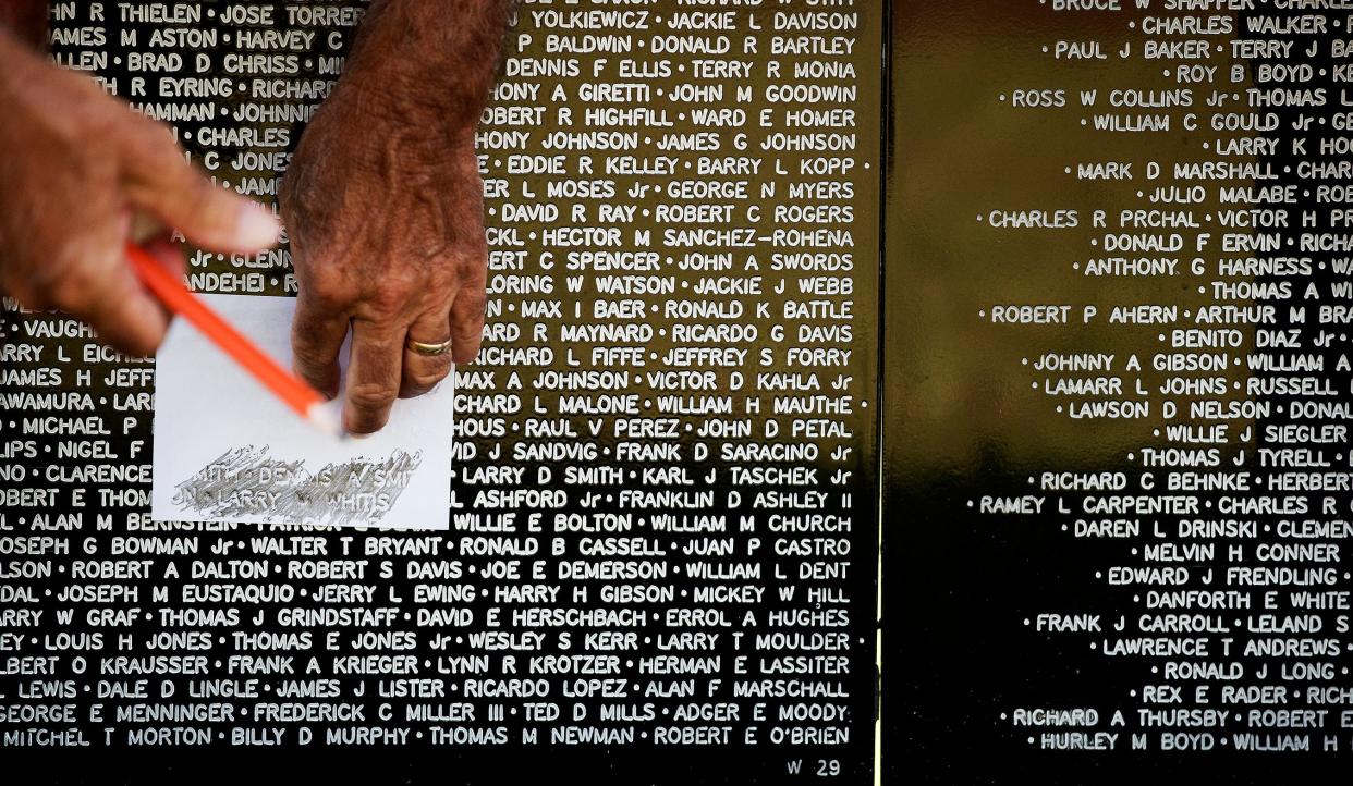 A man makes a rubbing of his brother's name during a Florida stop for the Vietnam Traveling Memorial Wall, which will be in Desert Hot Springs this week.