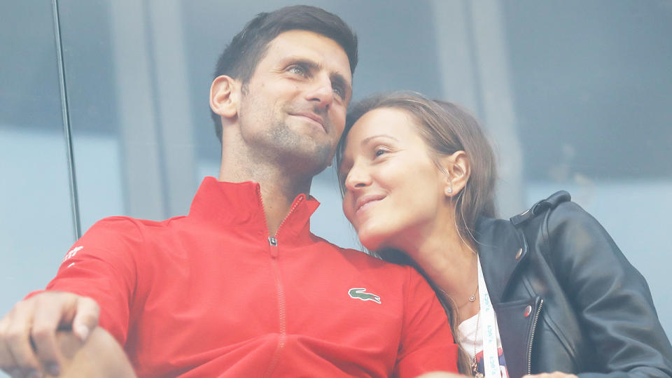 Novak Djokovic (pictured left) hugging his wife Jelena Djokovic (pictured right) in the stands.