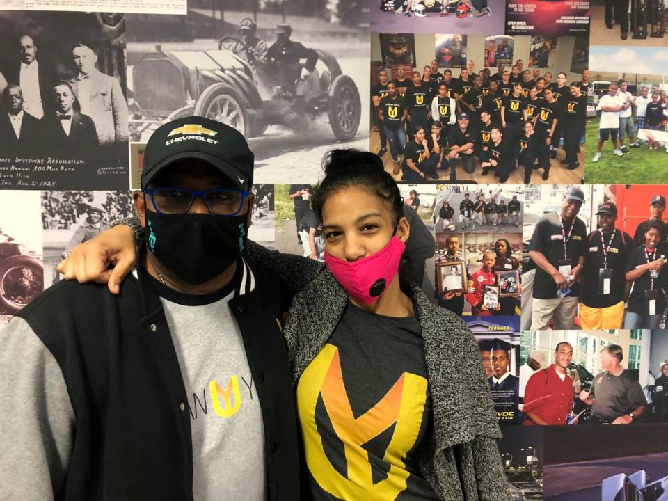 Urban Youth Racing School founder Anthony Martin, left, and his wife Michelle Martin pose for a photo at the school, Friday, Oct. 30, 2020, in Philadelphia. The school has made it its mission to introduce inner-city youngsters, most of them black, to the motorsports world. (AP Photo/Dan Gelston)