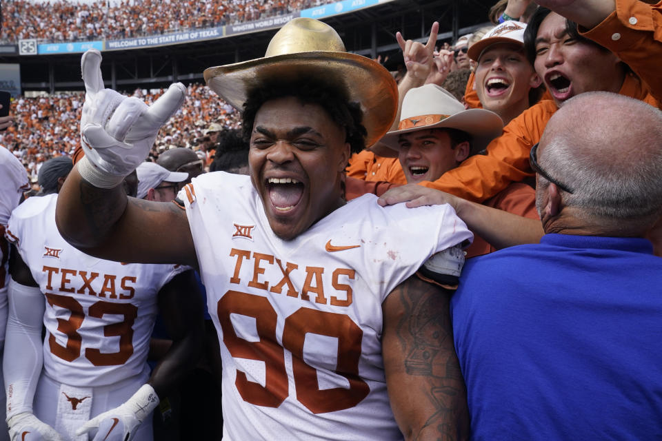 Texas defensive lineman Byron Murphy II (90) celebrates with the golden hat after an NCAA college football game against Oklahoma at the Cotton Bowl in Dallas, Saturday, Oct. 8, 2022. Texas won 49-0. (AP Photo/LM Otero)