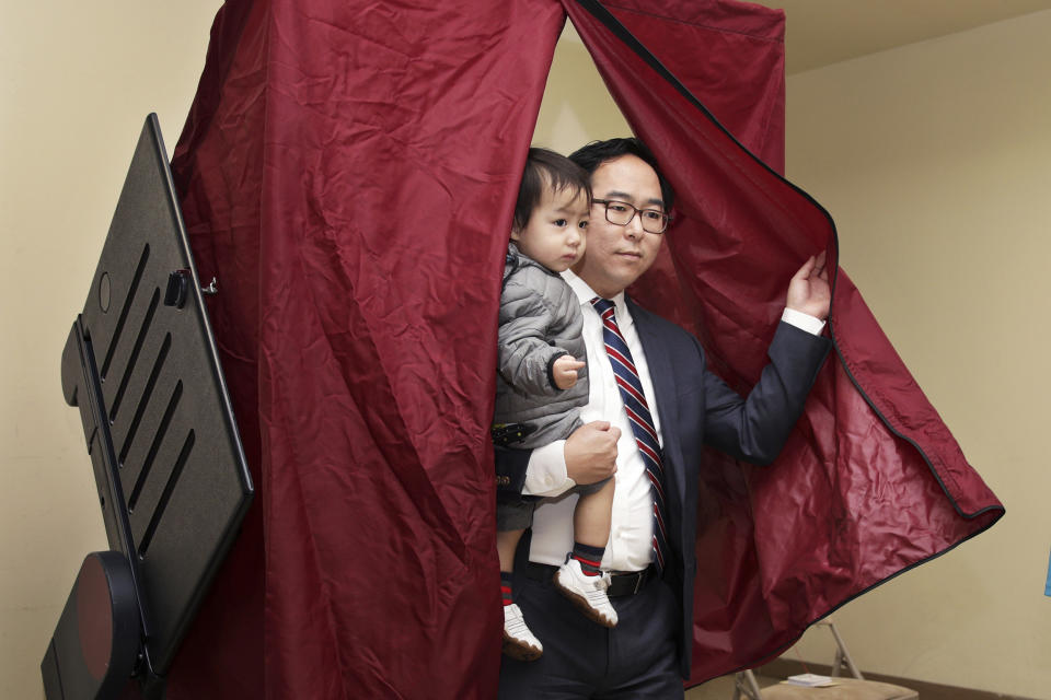 Then-candidate Andy Kim holds his son as he finishes voting onNov. 6, 2018, in Bordentown, N.J. (Mel Evans / AP file)
