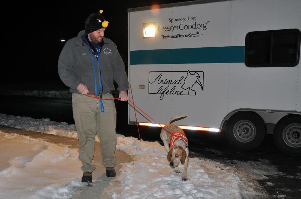 FILE - In this Dec. 19 photo provided by the American Society for the Prevention of Cruelty to Animals, ASPCA, shows staff member Tom Burke with a rescued dog arriving at St. Hubert’s Animal Welfare Center in Madison, N.J. Some 45 Tennessee dogs were rounded up at overcrowded shelters in Tennessee and brought to St. Hubert’s in Madison, N.J., which had enough open kennels for all the dogs, although they didn’t stay at the shelter very long before being adopted. (AP Photo/ASPCA, Anita Edson)