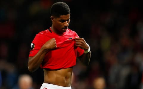 Marcus Rashford buries his head in his shirt - Credit: Action Images via Reuters/Jason Cairnduff