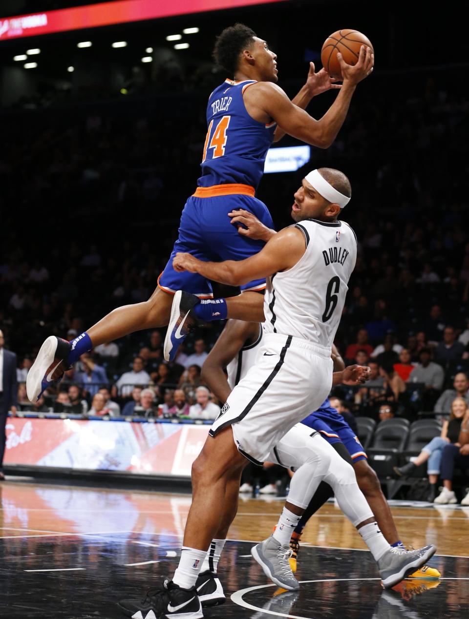 New York Knicks guard Allonzo Trier (14) goes to the basket against Brooklyn Nets forward Jared Dudley (6) during the second half of a preseason NBA basketball game Wednesday, Oct. 3, 2018, in New York. The Knicks won 107-102. (AP Photo/Noah K. Murray)