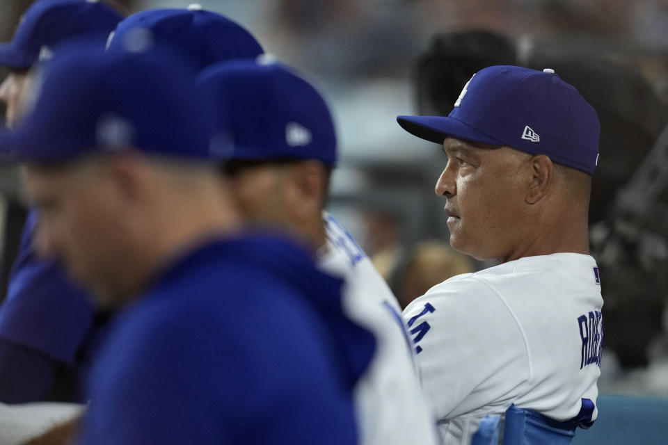 Los Angeles Dodgers manager Dave Roberts, right, looks on from the dugout during the seventh inning in Game 1 of a baseball NL Division Series against the Arizona Diamondbacks, Saturday, Oct. 7, 2023, in Los Angeles. (AP Photo/Ashley Landis)