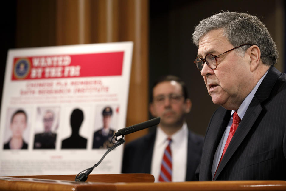 Attorney General William Barr speaks during a news conference, Monday, Feb. 10, 2020, at the Justice Department in Washington, as Principal Associate Deputy Attorney General Seth Ducharm looks on. Four members of the Chinese military have been charged with breaking into the networks of the Equifax credit reporting agency and stealing the personal information of tens of millions of Americans, the Justice Department said Monday, blaming Beijing for one of the largest hacks in history. (AP Photo/Jacquelyn Martin)