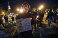 <p>Dana Farley of New Orleans participates in a candlelight vigil at the statue of Jefferson Davis in New Orleans, Mon., April 24, 2017.(Photo: Scott Threlkeld/AP) </p>