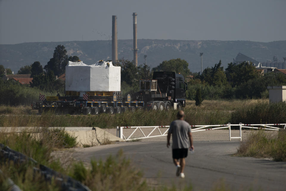 A central solenoid magnet for the ITER project departs from Berre-l'Etang in southern France, Monday, Sept. 6, 2021. The first part of a massive magnet so strong its American manufacturer claims it can lift an aircraft carrier arrived Thursday, Sept. 9, 2021 at a high-security site in southern France, where scientists hope it will help them build a 'sun on earth.' Almost 60-feet tall and 14 feet in diameter when fully assembled, the magnet is a crucial component of the International Thermonuclear Experimental Reactor, or ITER, a 35-nation effort to develop an abundant and safe source of nuclear energy for future generations. (AP Photo/Daniel Cole)