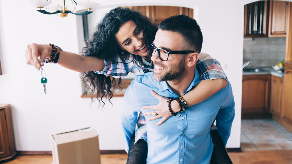 Young couple holding the keys for their new home