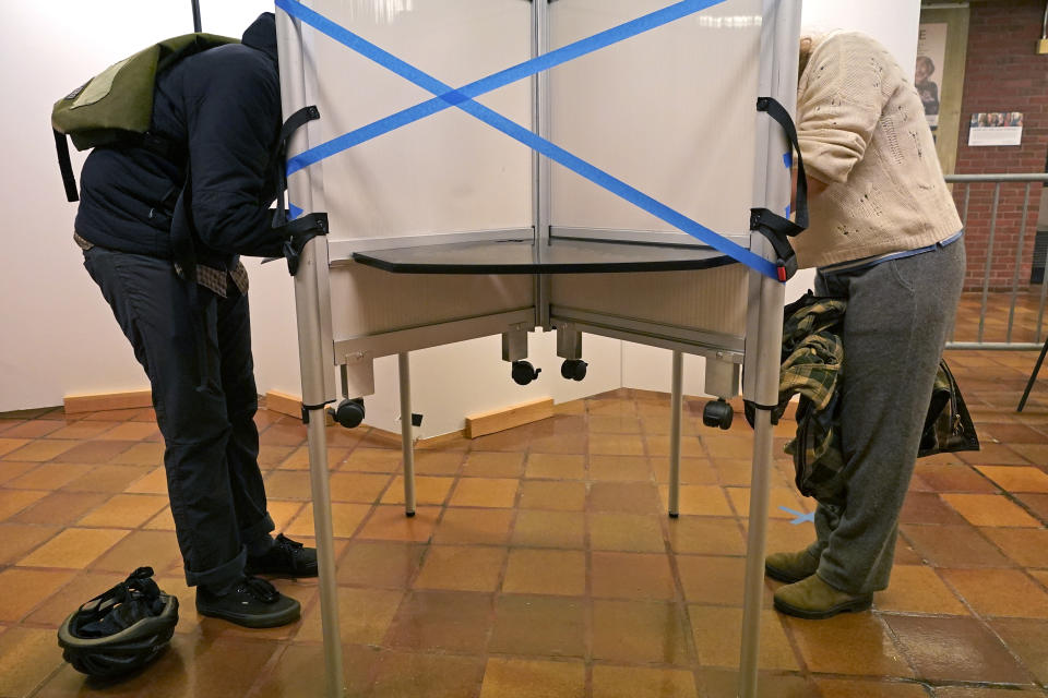 FILE - In this Monday, Oct. 26, 2020, file photo, voters cast ballots at Boston City Hall during early in-person voting, in Boston. Tens of millions of Americans already cast ballots in the 2020 election amid record-breaking early voting during the coronavirus pandemic. But for some voters in a handful of states, casting an early ballot in-person isn't even an option. (AP Photo/Elise Amendola, File)