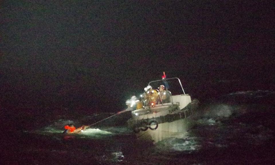 Coastguards rescuing a Filipino man off Amami Oshima island after the cargo ship sank