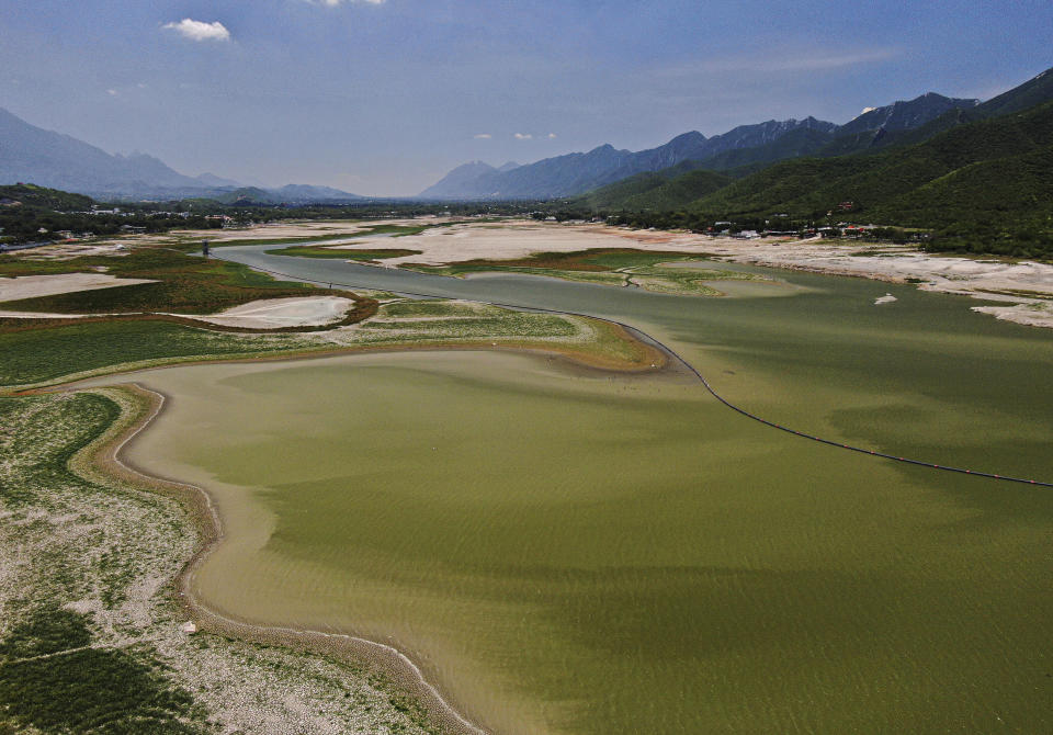 A view of The Boca reservoir that supplies water to the northern city of Monterrey is almost dry as the northern part of Mexico is affected by an intense drought, in Santiago, Mexico, Saturday, July 9, 2022. Local authorities began restricting water supplies in March, as a combination of an intense drought, poor planning and high use has left the three dams that help supply the city dried up, with thousands of homes not receiving any water for weeks. (AP Photo/Fernando Llano)