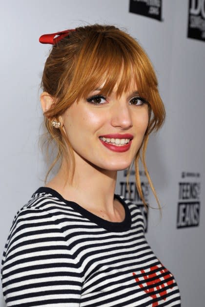 <p><strong>January 2013</strong></p> <p>The actress takes a red-lip leap, this time combining the effect with a ponytail secured with a bow and statement eye makeup.</p>