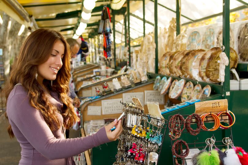 Girl buying souvenirs in Italy