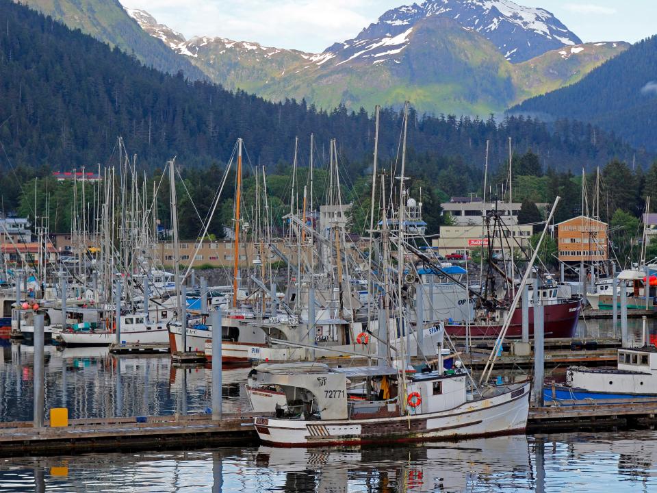 fishing boats in front of mountains in skita alaska