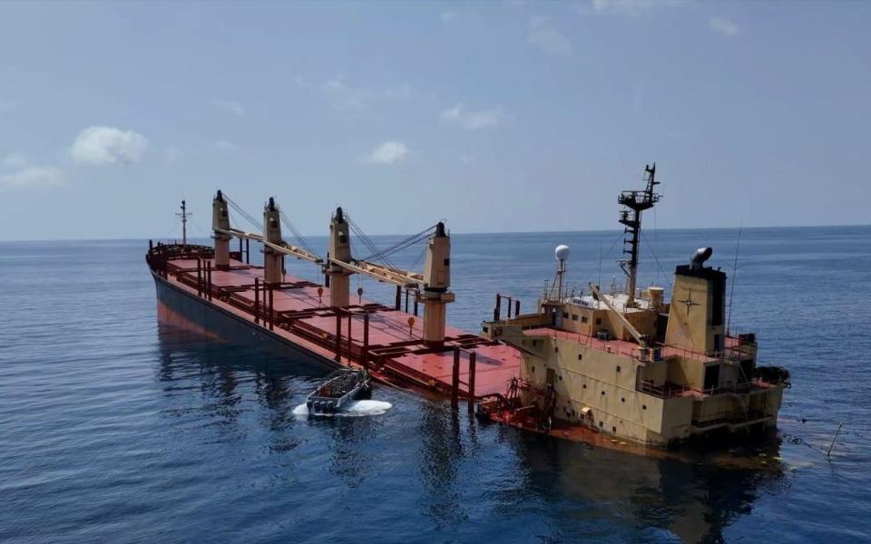 A handout photo made available by Yemeni Al-Joumhouriya TV shows the British-registered cargo vessel, Rubymar, sinking after being damaged in a missile attack by the Houthis in the Red Sea off the coast of Yemen