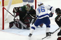 Arizona Coyotes goaltender Antti Raanta, left, makes a save on a shot by Tampa Bay Lightning right wing Nikita Kucherov (86) during the first period of an NHL hockey game Saturday, Feb. 22, 2020, in Glendale, Ariz. (AP Photo/Ross D. Franklin)