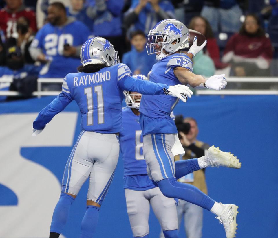 Detroit Lions wide receiver Amon-Ra St. Brown (14) celebrates his touchdown against the Arizona Cardinals with wide receiver Kalif Raymond (11) during the first half on Sunday, December 19, 2021 at Ford Detroit Field.