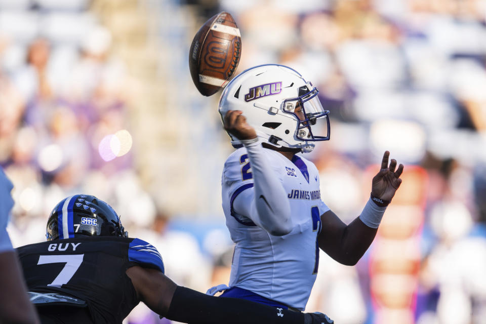 Georgia State cornerback Izaiah Guy (7) hits James Madison Dukes quarterback Jordan McCloud (2) and causes a fumble in the first half of an NCAA college football game Saturday, Nov. 4 2023, in Atlanta. (AP Photo/Hakim Wright Sr.)