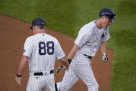 New York Yankees' DJ LeMahieu celebrates with third base coach Phil Nevin, left, as he runs the bases after hitting a two-run home run during the third inning of the team's baseball game against the Oakland Athletics on Friday, June 18, 2021, in New York. (AP Photo/Frank Franklin II)