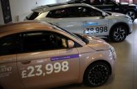 Used electric vehicles are seen for sale inside the showroom of a used car dealer in Manchester