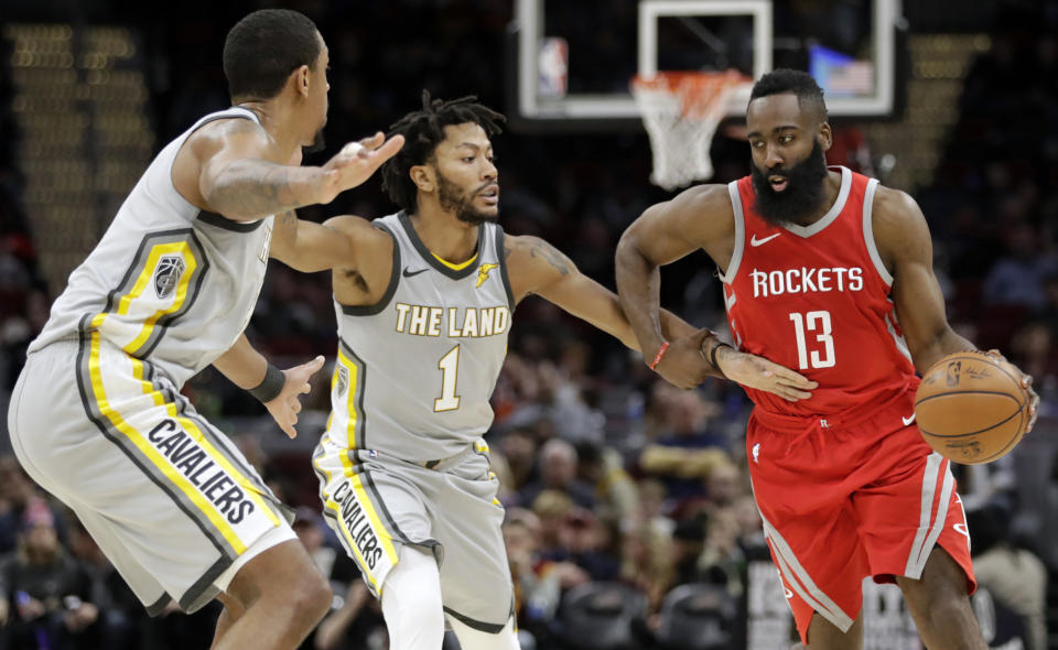 Houston Rockets’ James Harden, right, drives past Cleveland Cavaliers’ Channing Frye, left, and Derrick Rose in the second half of an NBA basketball game, Saturday, Feb. 3, 2018, in Cleveland. The Rockets won 120-88. (AP Photo/Tony Dejak)