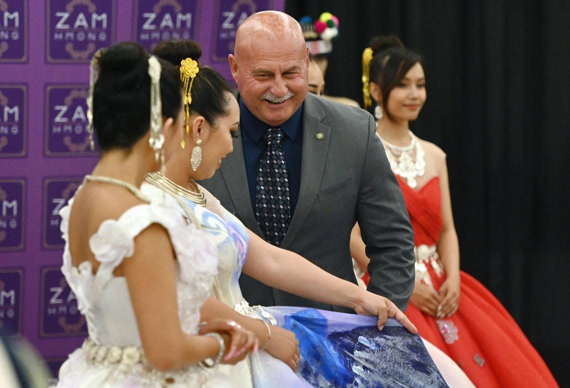 Fresno Mayor Jerry Dyer poses with fashion models at the 2023 Hmong American Day celebration hed at The Fresno Center Saturday, May 13, 2023 in Fresno. The event which included a ramen bar, music and fashion featured a proclamation by Fresno Mayor Jerry Dyer recognizing Hmong American Day and the history and contributions of the Hmong to the Valley.