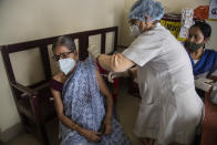 An elderly woman receives the AstraZeneca vaccine for COVID-19 at a government run in Gauhati, India, Saturday, May 8, 2021. Infections have swelled in India since February in a disastrous turn blamed on more contagious variants as well as government decisions to allow massive crowds to gather for religious festivals and political rallies. ​(AP Photo/Anupam Nath)