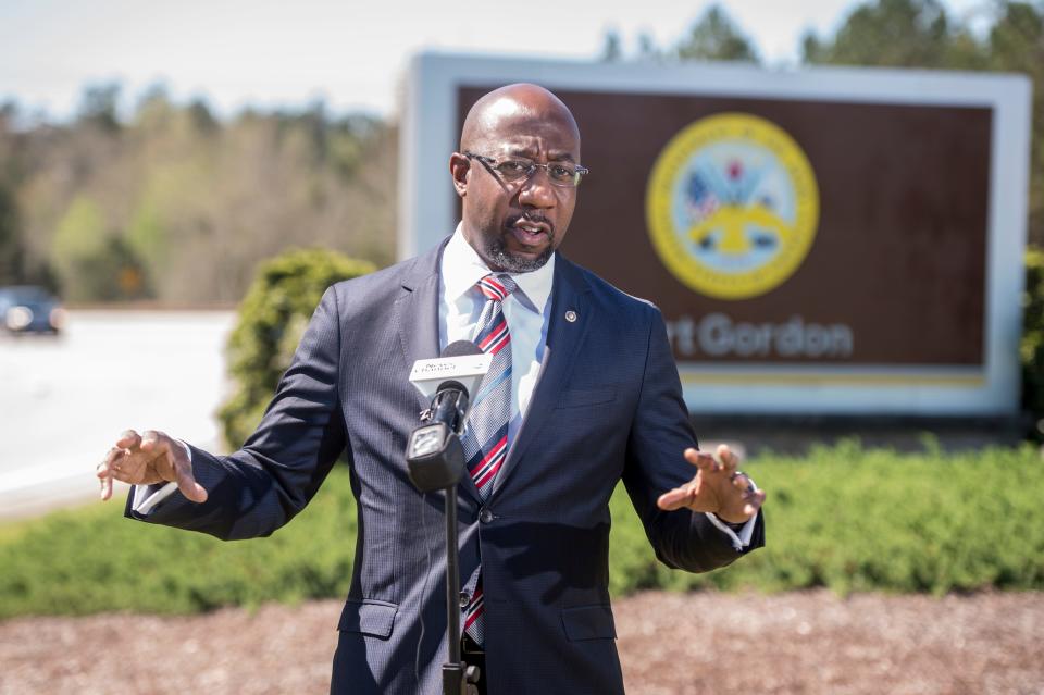 FILE - U.S. Sen. Raphael Warnock talks with reporters outside Fort Gordon after touring the facility near Augusta, Ga., Monday morning March 29, 2021.