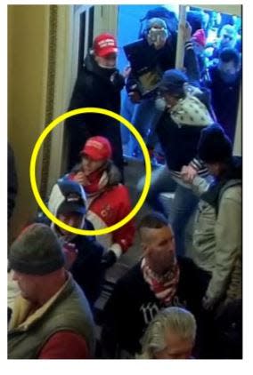 Surveillance video shows the woman in the American flag jacket enter the U.S. Capitol through a broken window near the Senate Wing Door. The woman remained in the Senate Wing Door lobby area for a period of time where she took pictures and engaged with U.S. Capitol Police officers.