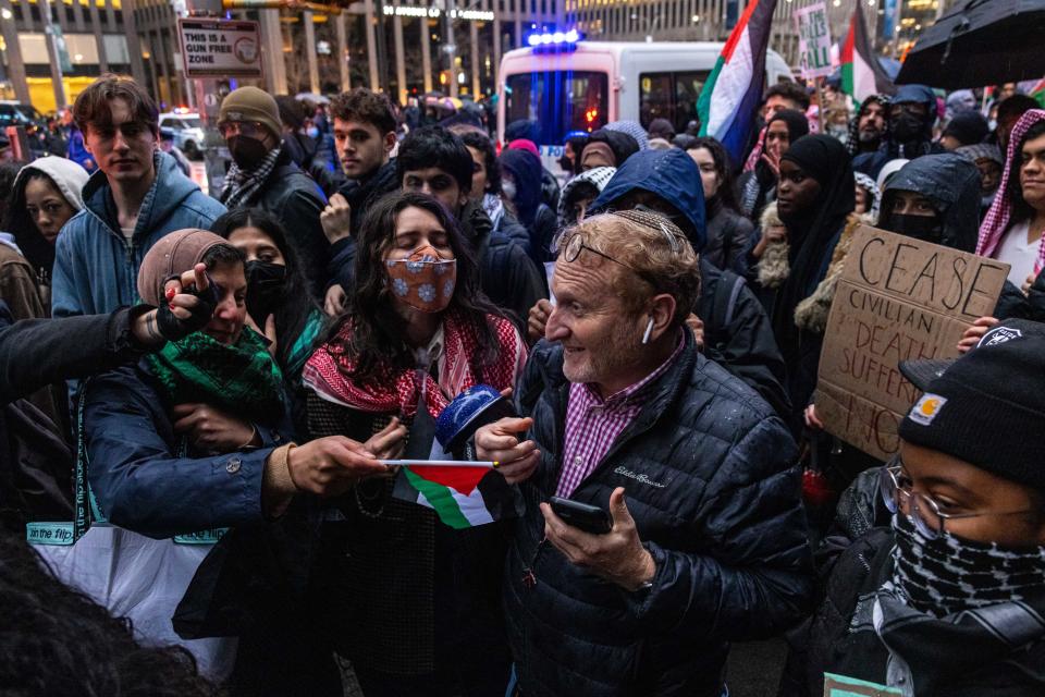 Pro-Palestinian demonstrators confront a passerby on the street who verbally argued with them near Radio City Music Hall during President Joe Biden's fundraiser on March 28, 2024 in New York City. Biden will be joined by former presidents Bill Clinton and Barack Obama at the fundraiser.