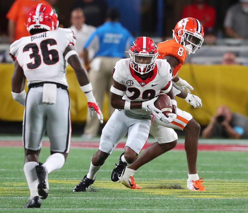 Georgia defensive back Christopher Smith intercepts a pass intended for Clemson wide reciever Justyn Ross, right, and goes on to score a touchdown during the second quarter of an NCAA college football game Saturday, Sept. 4, 2021, in Charlotte, N.C.