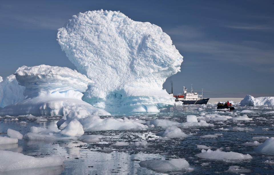 In this Dec. 2, 2009 photo provided by Aurora Expeditions, an inflatable boat carries tourists past an iceberg along the Antarctic Peninsula. In a remote, frozen, almost pristine land where the only human residents are involved in research, tourism comes with risks, for both the continent and the tourists. (AP Photo/Aurora Expeditions, Andrew Halsall) EDITORIAL USE ONLY