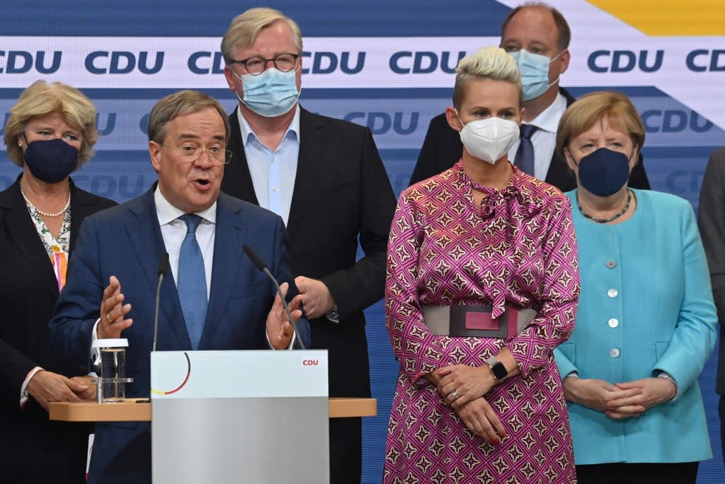 German Chancellor Angela Merkel on stage as CDU leader and Chancellor candidate Armin Laschet addresses an audience in Berlin  (AFP via Getty Images)