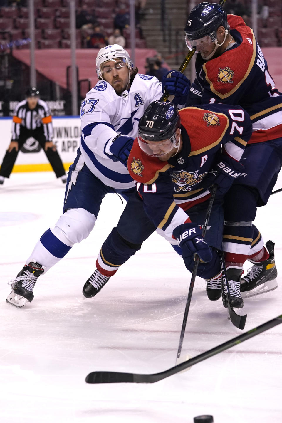 Tampa Bay Lightning defenseman Ryan McDonagh, left, Florida Panthers right wing Patric Hornqvist (70) and Panthers center Aleksander Barkov, right, go for the puck during the second period of an NHL hockey game, Saturday, Feb. 13, 2021, in Sunrise, Fla. (AP Photo/Lynne Sladky)
