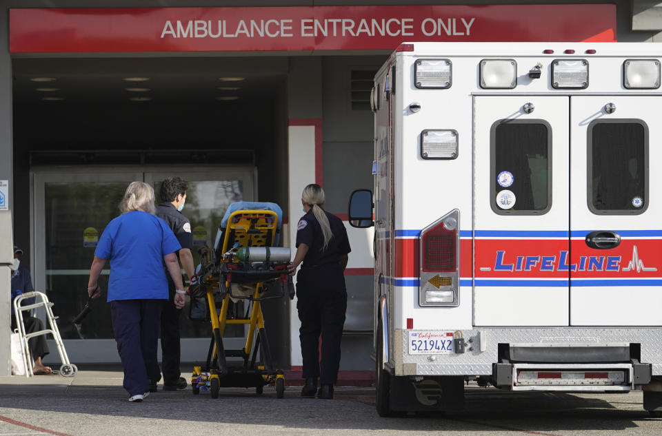 FILE - In this Jan. 5, 2021 file photo a LifeLine Ambulance arrives at the CHA Hollywood Presbyterian Medical Center (CHA HPMC) in Los Angeles. California health authorities reported on Saturday, Jan. 9, 2021, a record high of 695 coronavirus deaths as many hospitals strain under unprecedented caseloads. The state Department of Public Health says the number raises the state's death toll since the start of the pandemic to 29,233. (AP Photo/Damian Dovarganes, File)