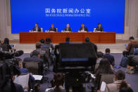 Ning Jizhe, center, commissioner of China's National Bureau of Statistics, speaks during a press conference at the State Council Information Office in Beijing, Tuesday, May 11, 2021. China's population growth is falling closer to zero as fewer couples have children, the government announced Tuesday, adding to strains on an aging society with a shrinking workforce. (AP Photo/Mark Schiefelbein)