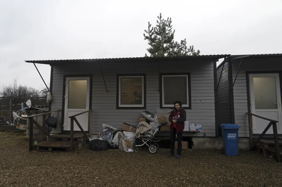50-year-old Natalia Zhyvohliad, a displaced person from Nova Petrivka in the Zaporizhzhia region of Ukraine, is pictured standing outside her temporary modular house in Kolomyya, Ivano-Frankivsk region on Feb. 13, 2024. Russia has successfully imposed its passports on nearly the entire population of occupied Ukraine by making it impossible to survive without them, coercing hundreds of thousands of people into citizenship. (AP Photo/Vasilisa Stepanenko)
