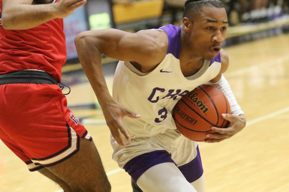 Clarksville's J.J. Wheat holds the ball close to his body as he makes his move to the basket against Henry County during their Region 7-4A tournament semifinal game Tuesday, March 1, 2022 at Kenwood High School.
