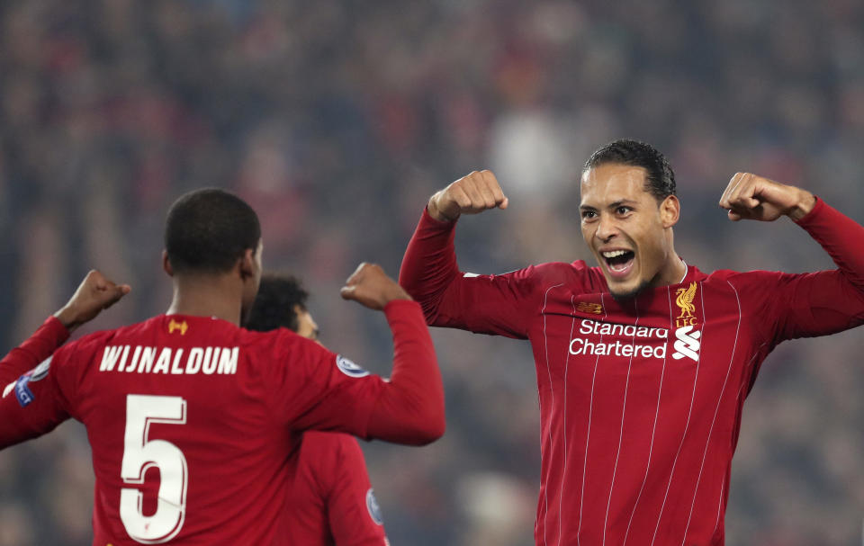 Liverpool's Georginio Wijnaldum, left, celebrates with Virgil van Dijk after scoring the opening goal during the Champions League group E soccer match between Liverpool and Genk at Anfield Stadium, Liverpool, England, Tuesday, Nov. 5, 2019. (AP Photo/Jon Super)